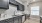 a kitchen with dark grey cabinets