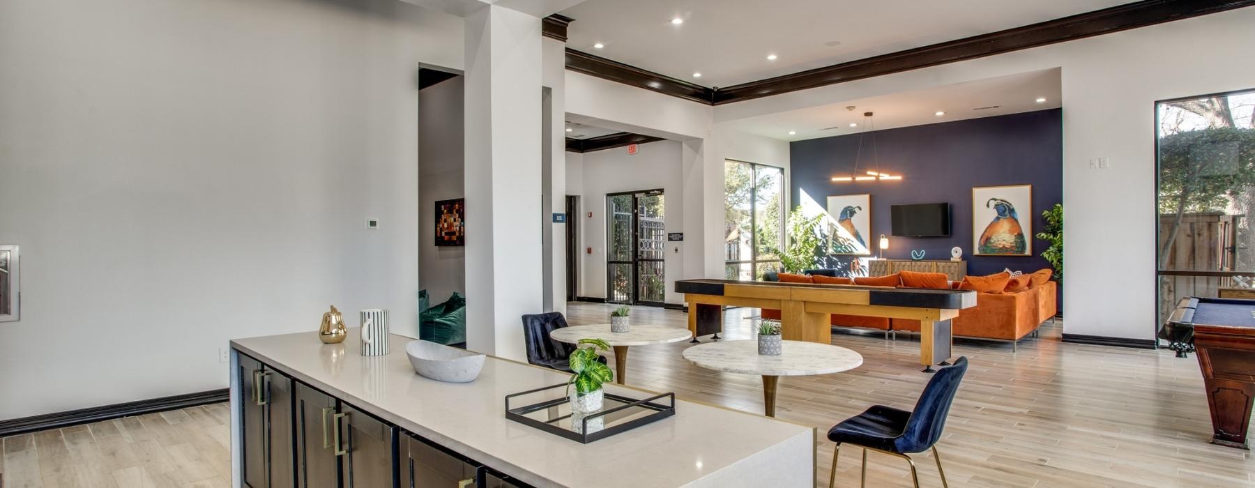 a clubhouse with an island and seating