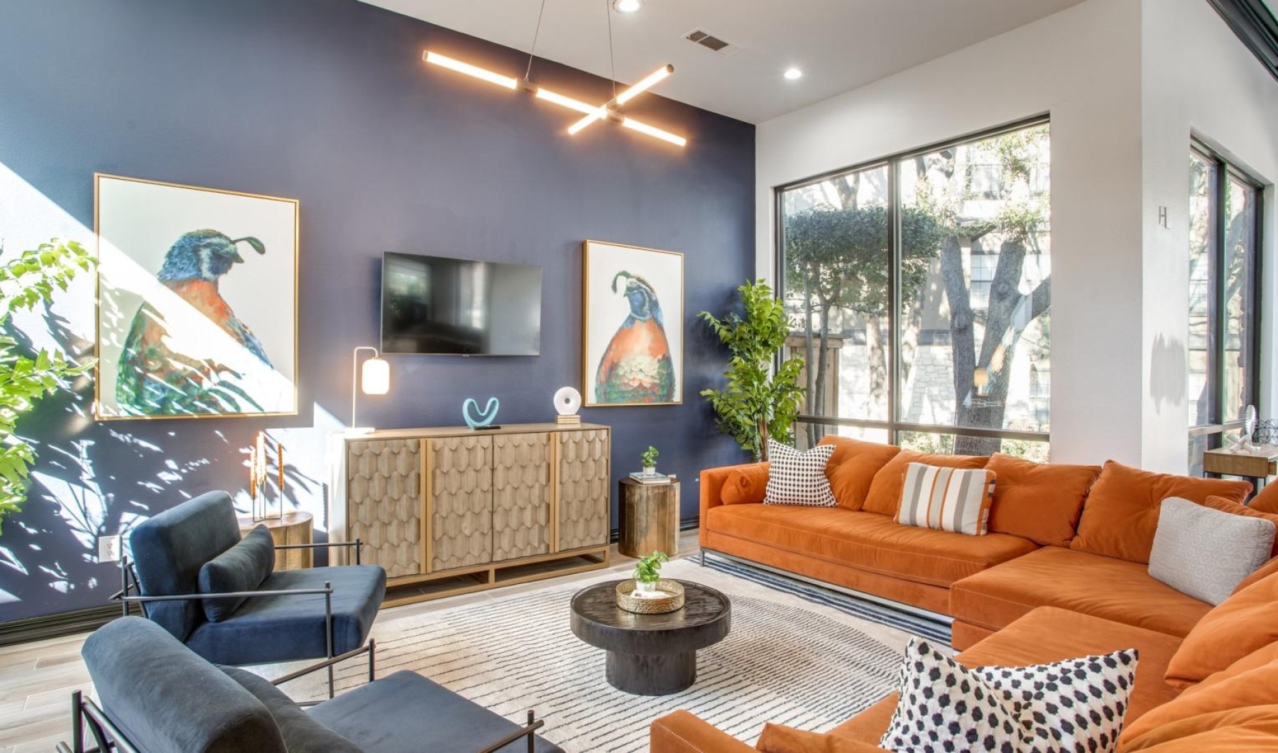 a lounge with a large couch and windows