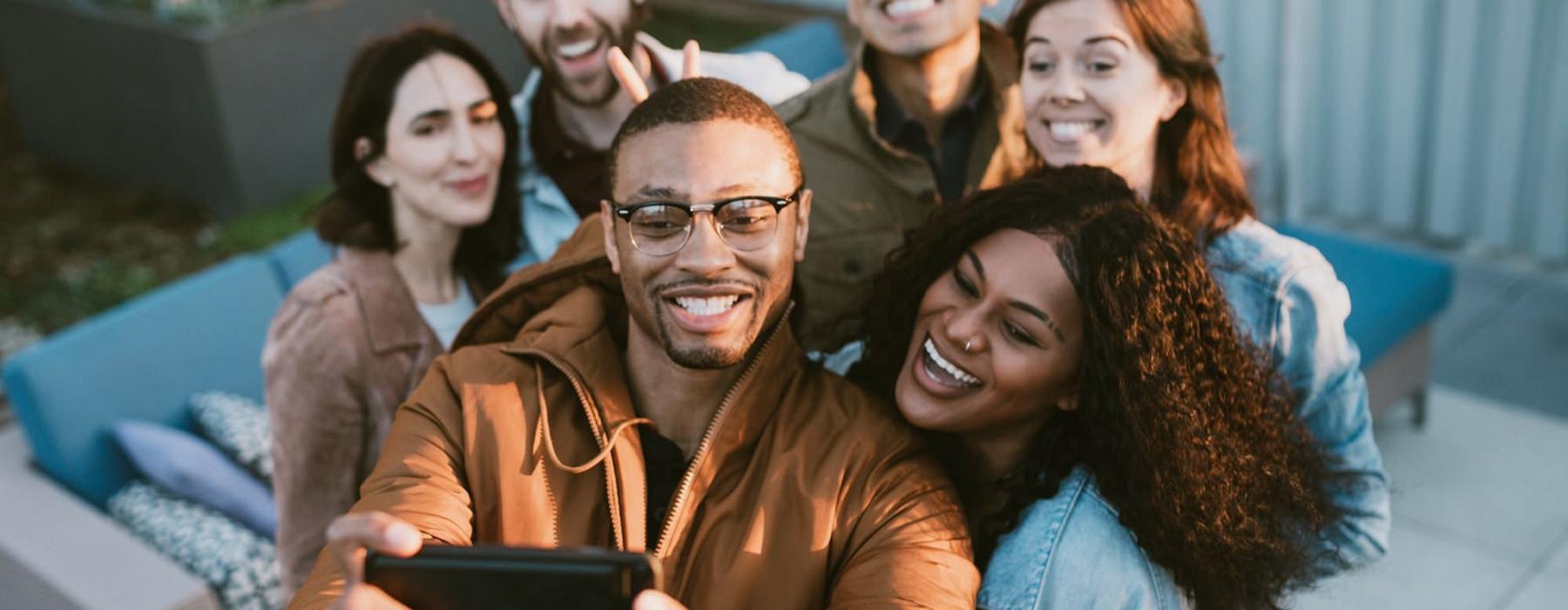 friends take a group selfie outdoors