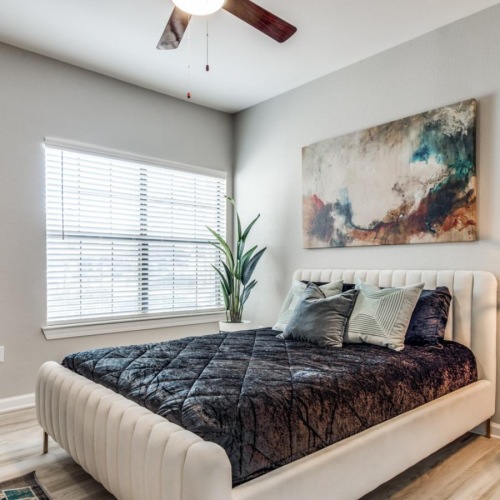 a bedroom with a bed and a lamp