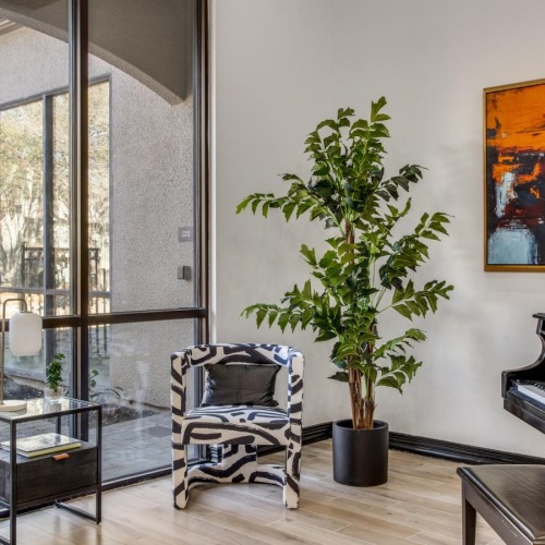 Find your perfect fit at The Vincent a room with a seating piano and a plant